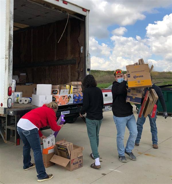  Smith-Cotton High School DECA members load donated pet supplies onto a truck for delivery.