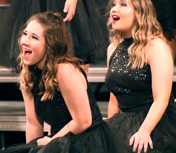 Cassidey Polley, left, performs with the New Score show choir in January 2020.
