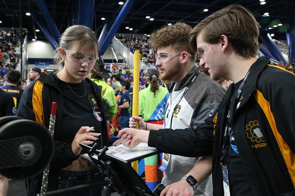  Team SCREAM drive team members discuss match strategy.