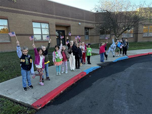 Skyline Elementary students get ready to place American flags around the school for Veterans Day.